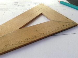 Close-up of a wooden ruler on paper, ideal for educational themes and measuring concepts.